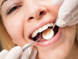 Close-up picture of a smiling woman having a dental cleaning procedure in Costa Rica.